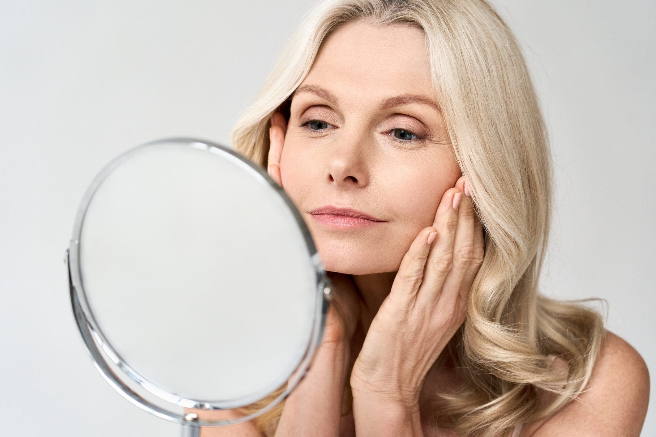 Woman touching her face after Juvéderm Vollure treatment