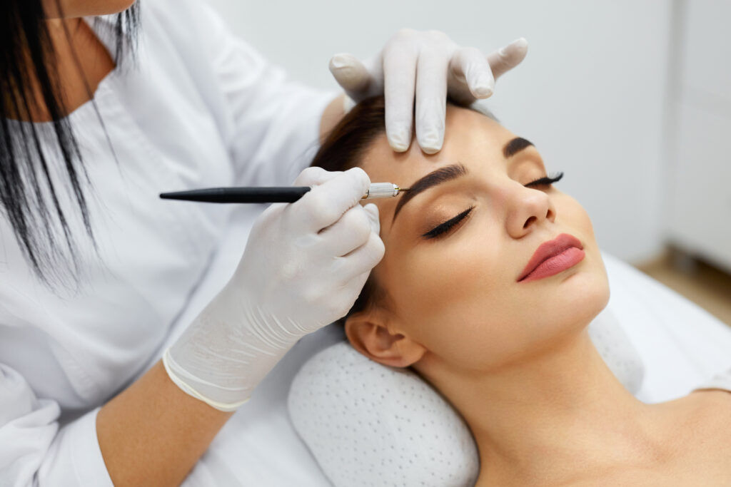 Woman undergoing brow shaping and tint