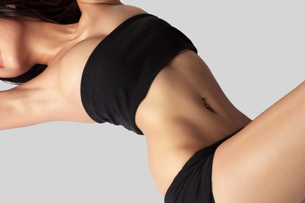 Woman with flat abdomen after Kybella for body treatment